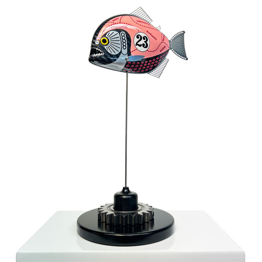 Carbon fibre piranha sculpture with Porsche Pink Pig livery on a black base with F1 gear