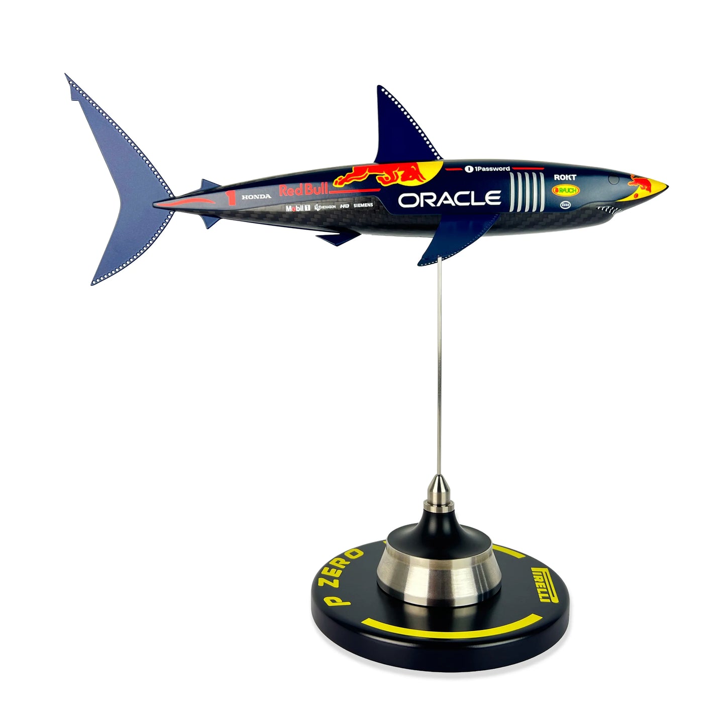Carbon Fibre Sculpture of a shark with RedBull racing livery on a stand against a white background