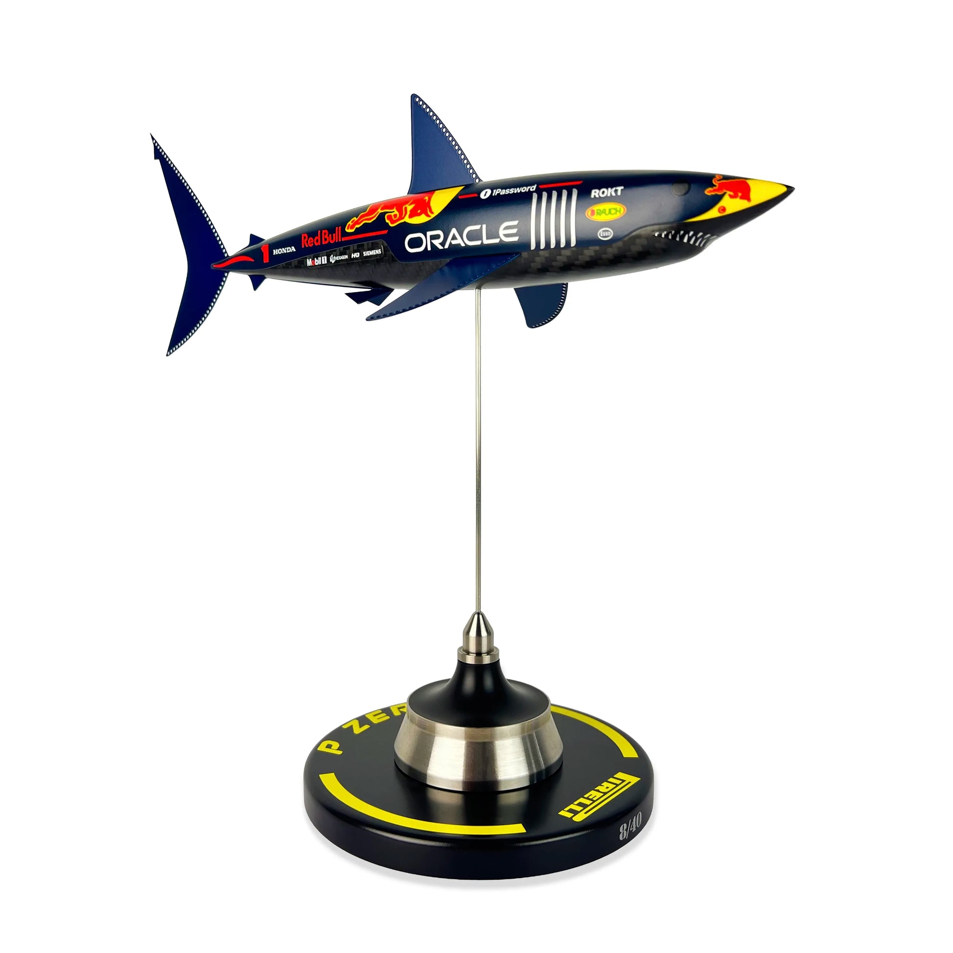 Carbon Fibre Sculpture of a shark with RedBull racing livery on a stand against a white background