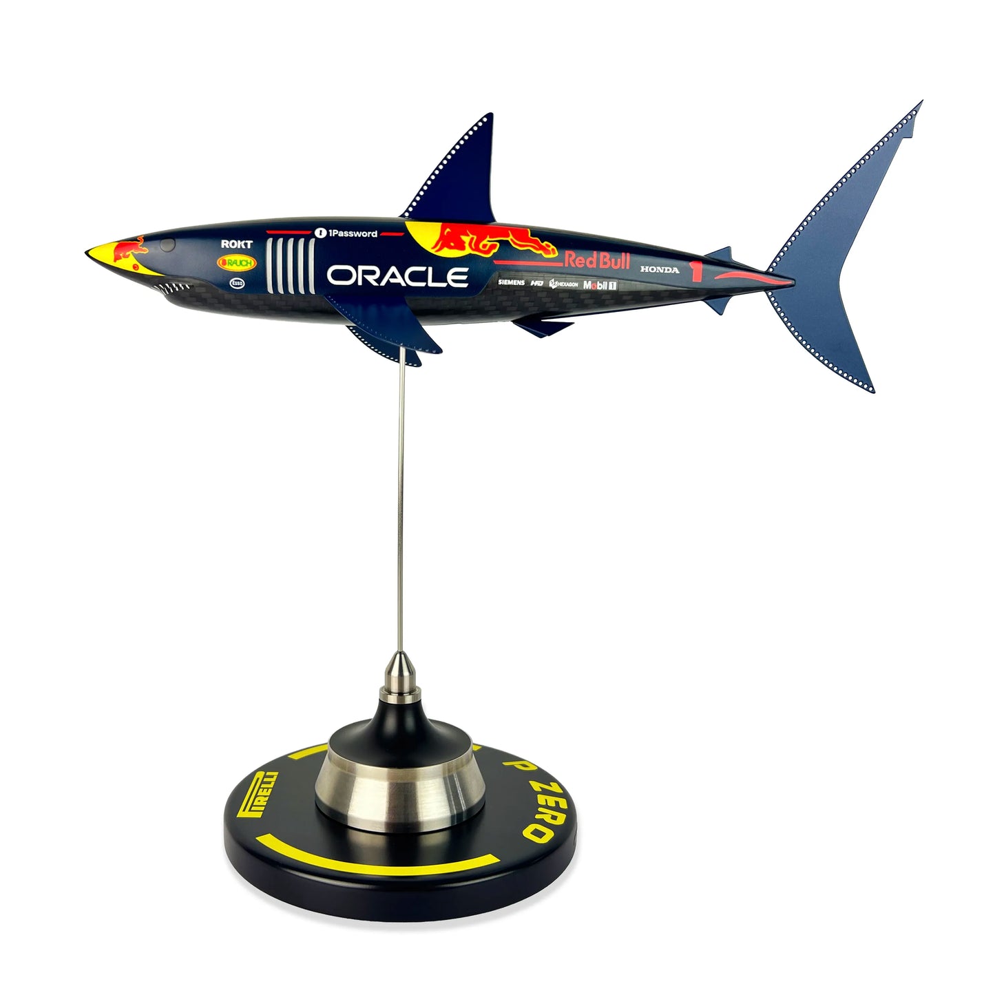 Carbon Fibre Sculpture of a shark with RedBull racing livery on a stand against a white background