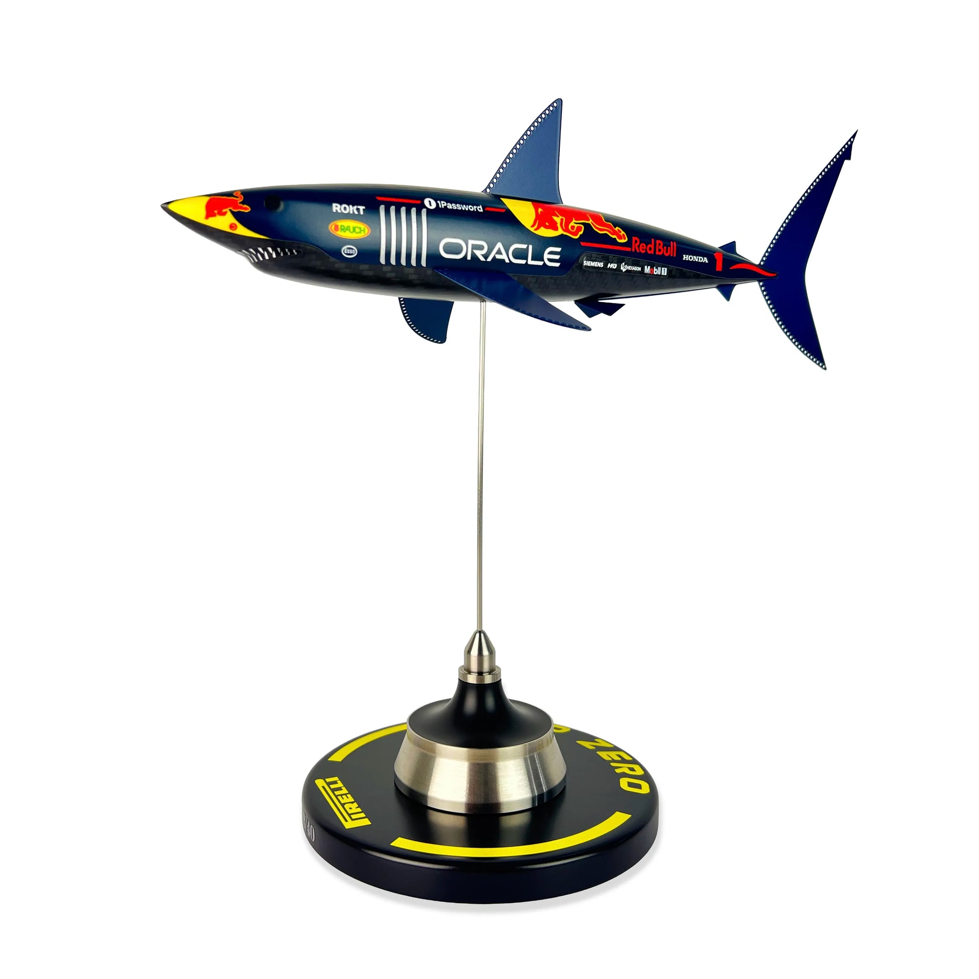 Carbon Fibre Sculpture of a shark with RedBull racing livery on a stand against a white background