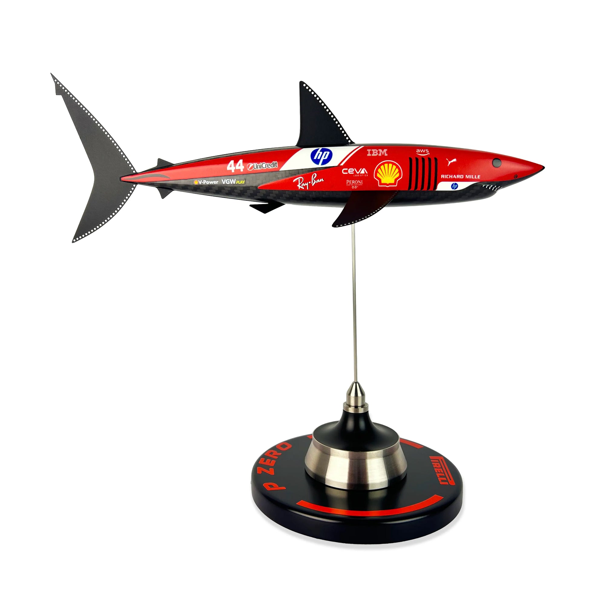Carbon Fibre Sculpture of a shark with Ferrari Inspired racing livery on a stand against a white background