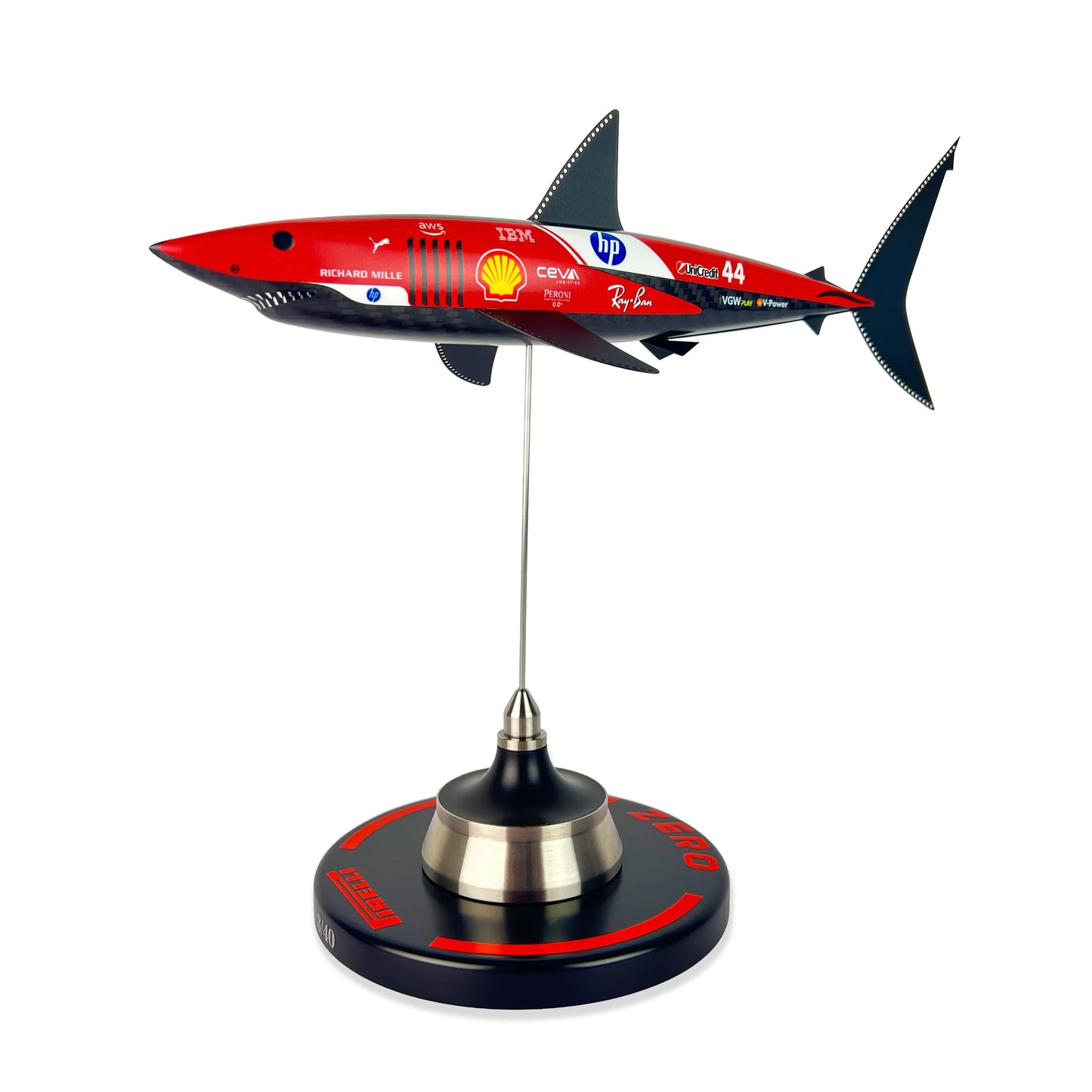 Carbon Fibre Sculpture of a shark with Ferrari Inspired racing livery on a stand against a white background