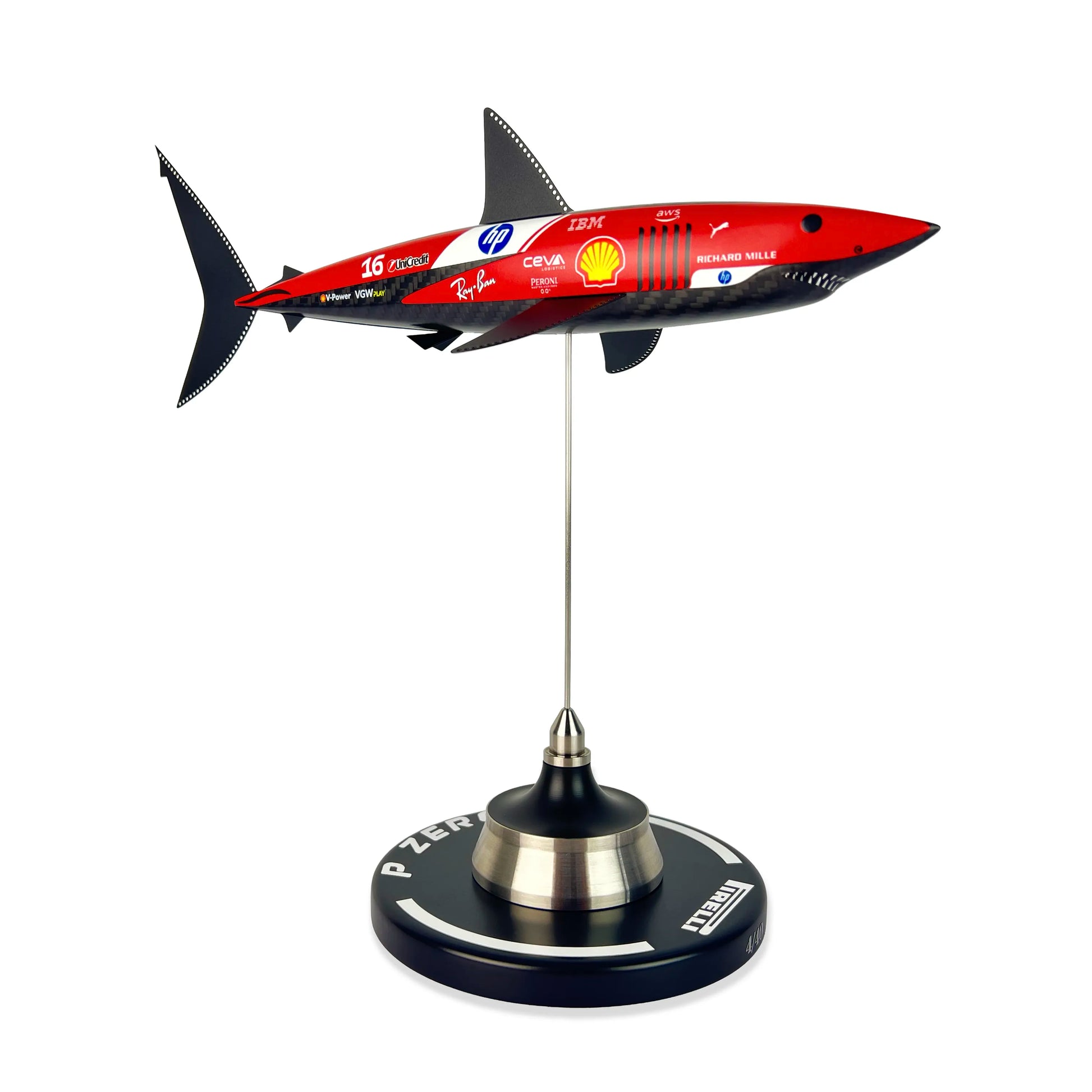 Carbon Fibre Sculpture of a shark with Ferrari Inspired racing livery on a stand against a white background