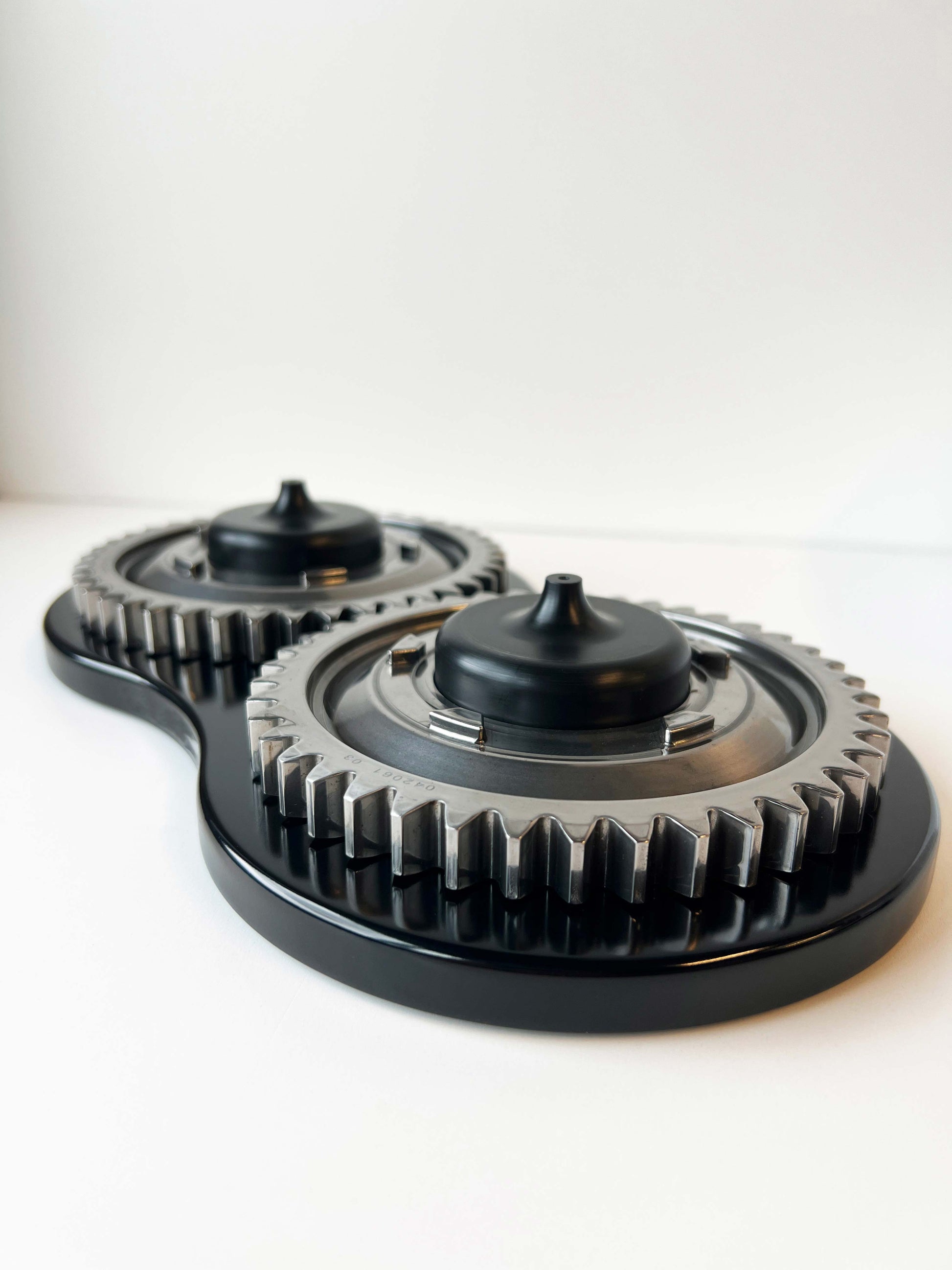 Two F1 Gears on black wooden base