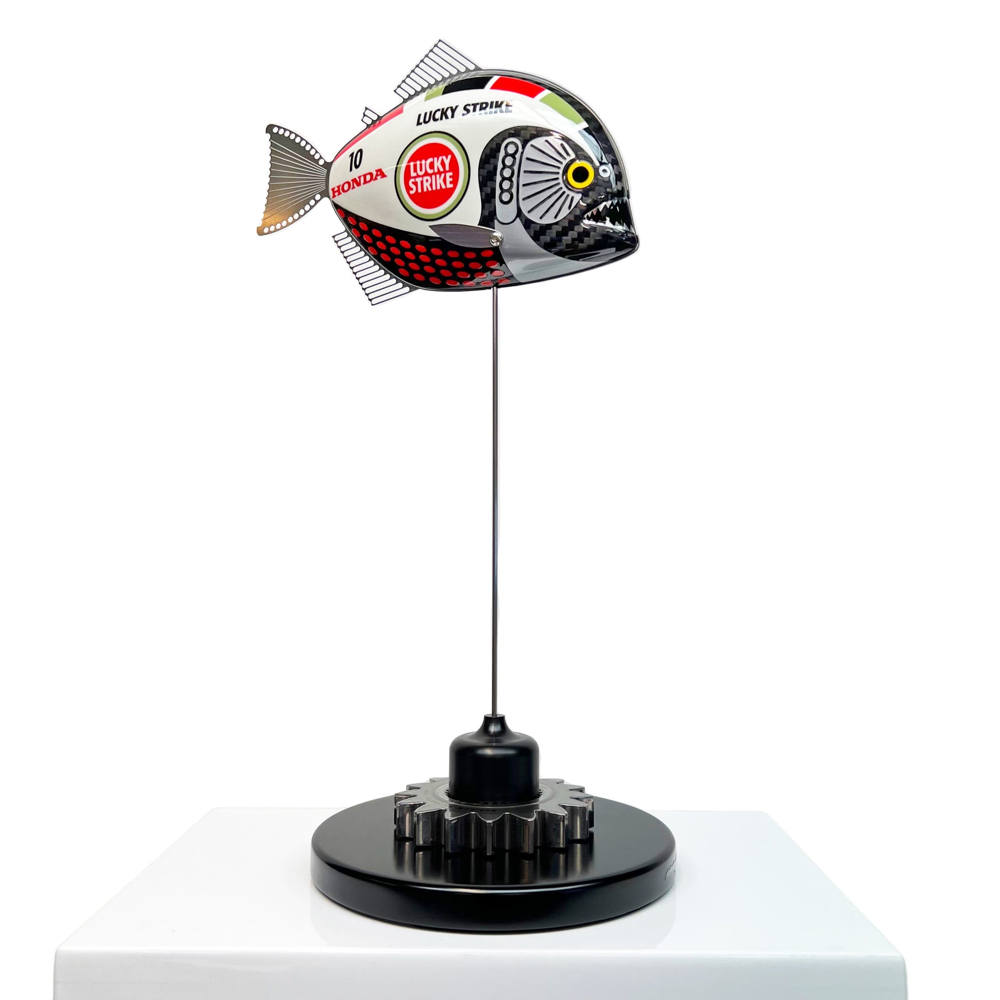 Carbon fibre baby piranha sculpture with BAR Honda F1 livery on a black base with F1 gear