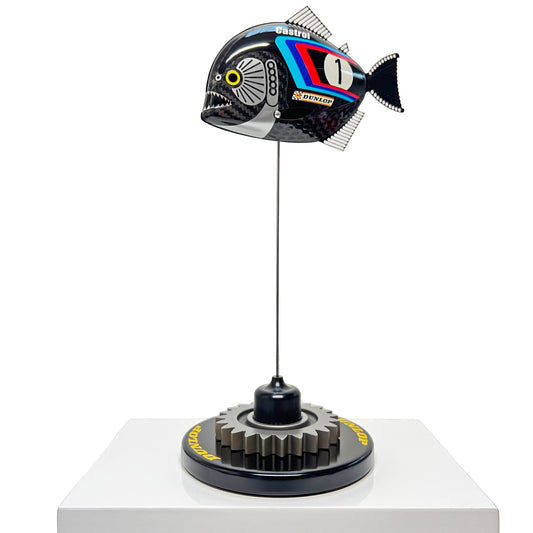 Carbon fibre baby piranha sculpture with BMW livery on a black base with F1 gear