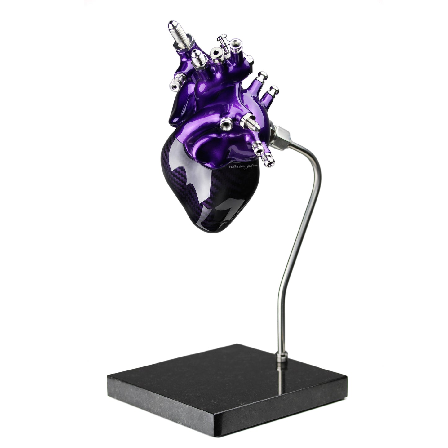 Carbon fibre human heart with purple tint and painted detail on a granite base