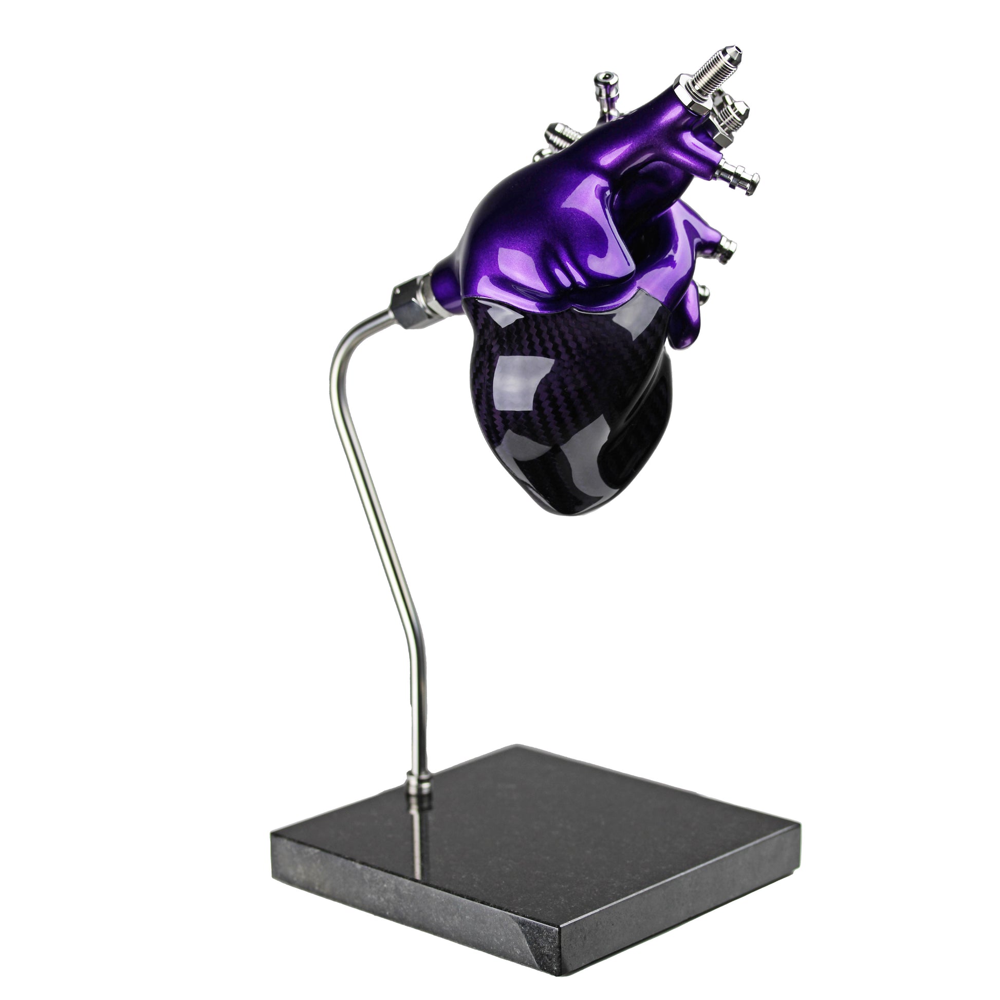 Carbon fibre human heart with purple tint and painted detail on a granite base