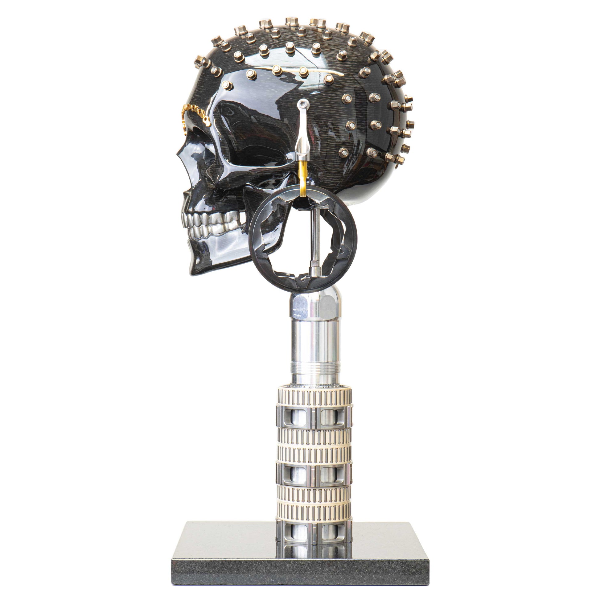 Carbon fibre human skull with F1 parts on a granite base