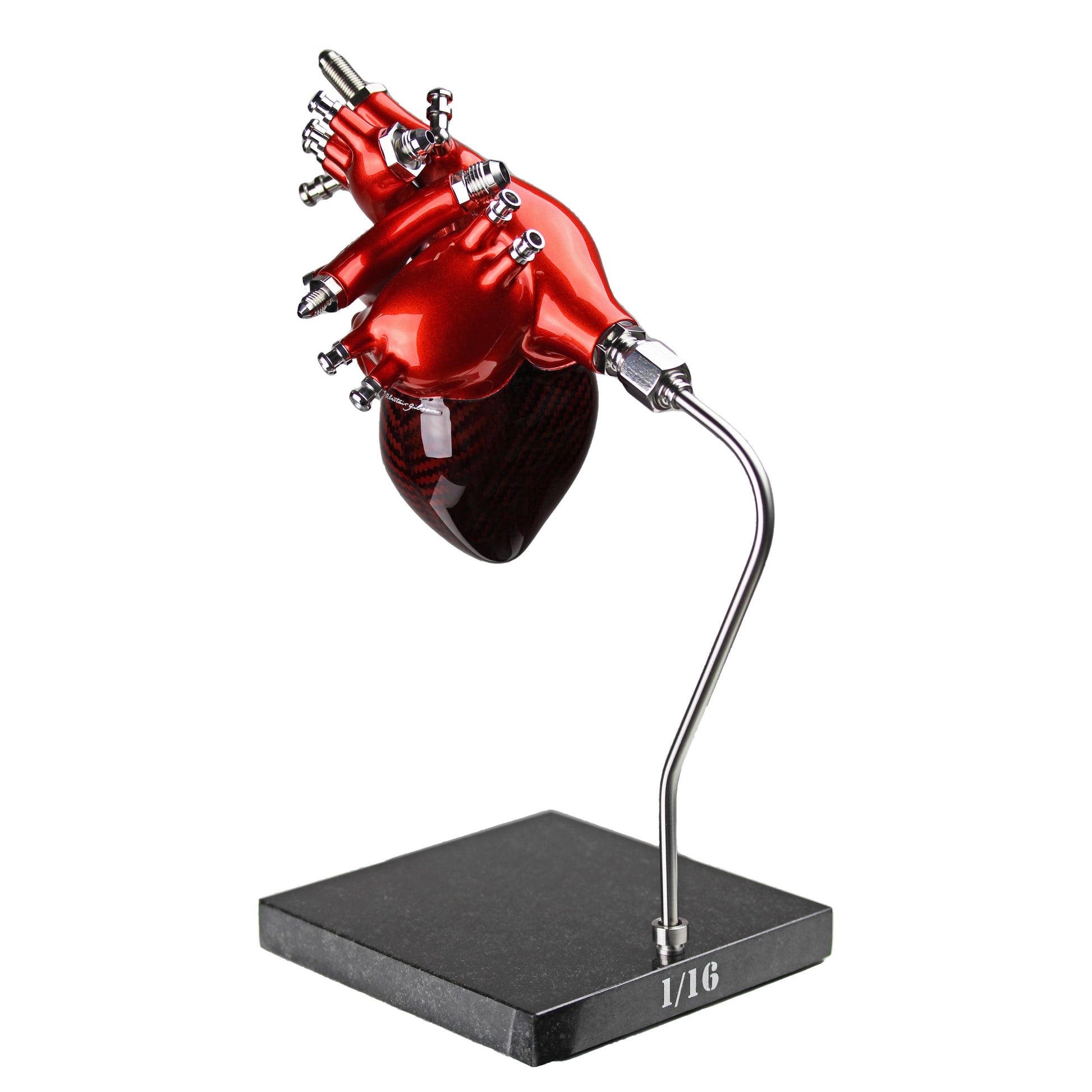 Carbon fibre Human Heart with red tint and red painted detail on a granite base