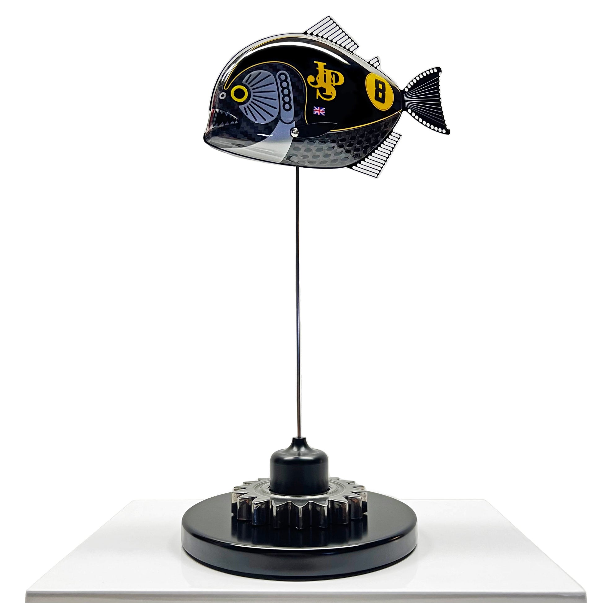 Carbon fibre Piranha sculpture with JPS livery on a black base with F1 gear