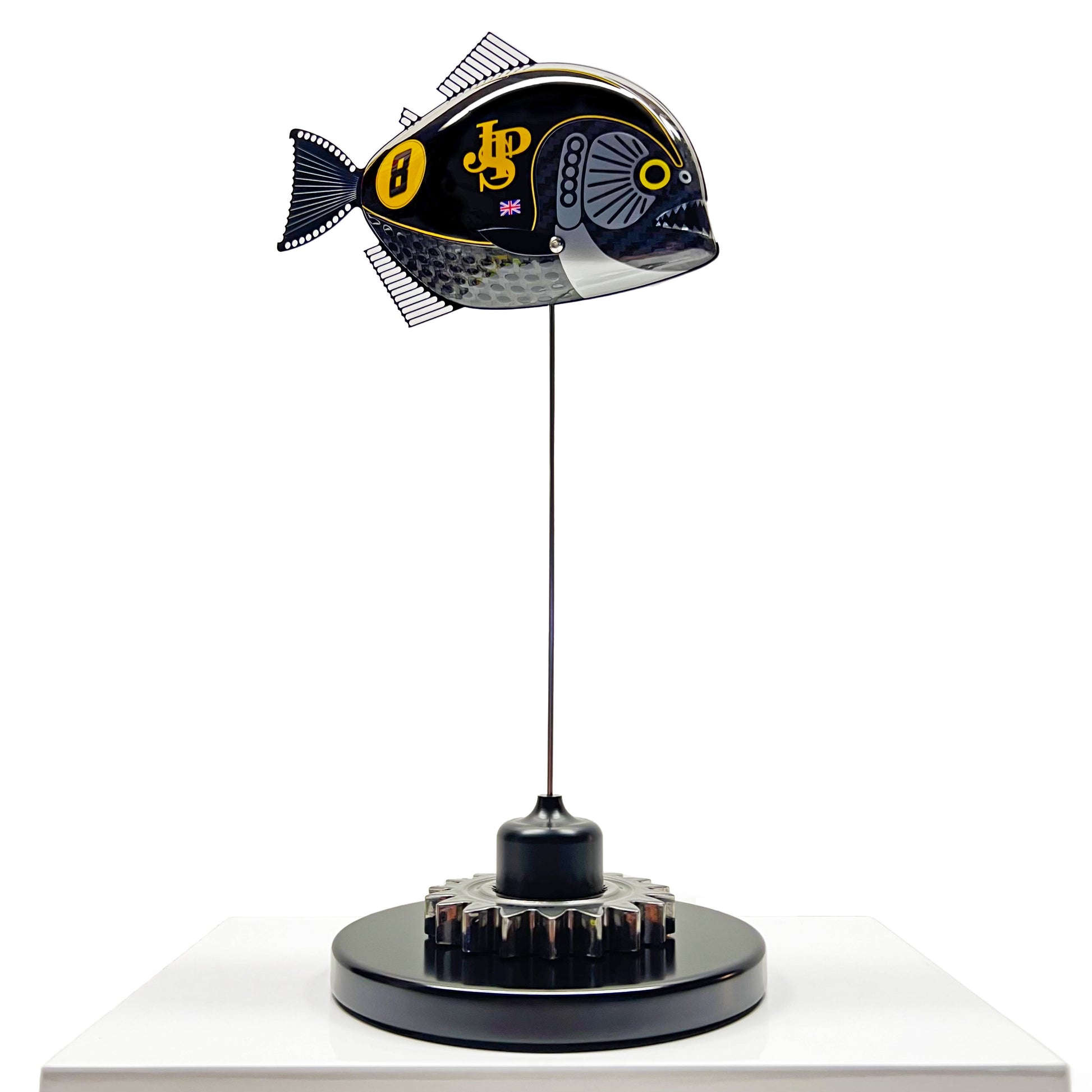 Carbon fibre Piranha sculpture with JPS livery on a black base with F1 gear