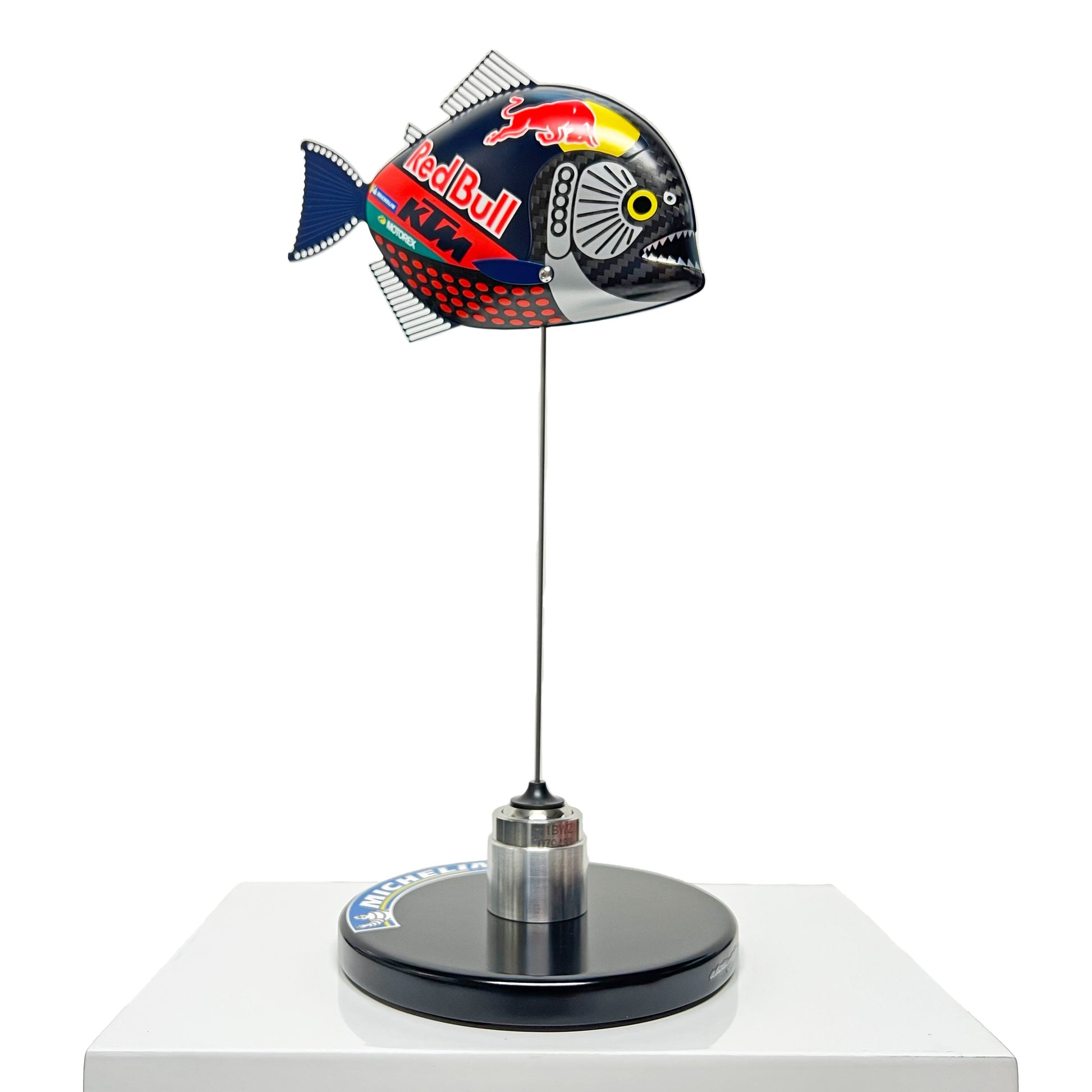 Carbon fibre Piranha sculpture with KTM Redbull livery on a black base with F1 part