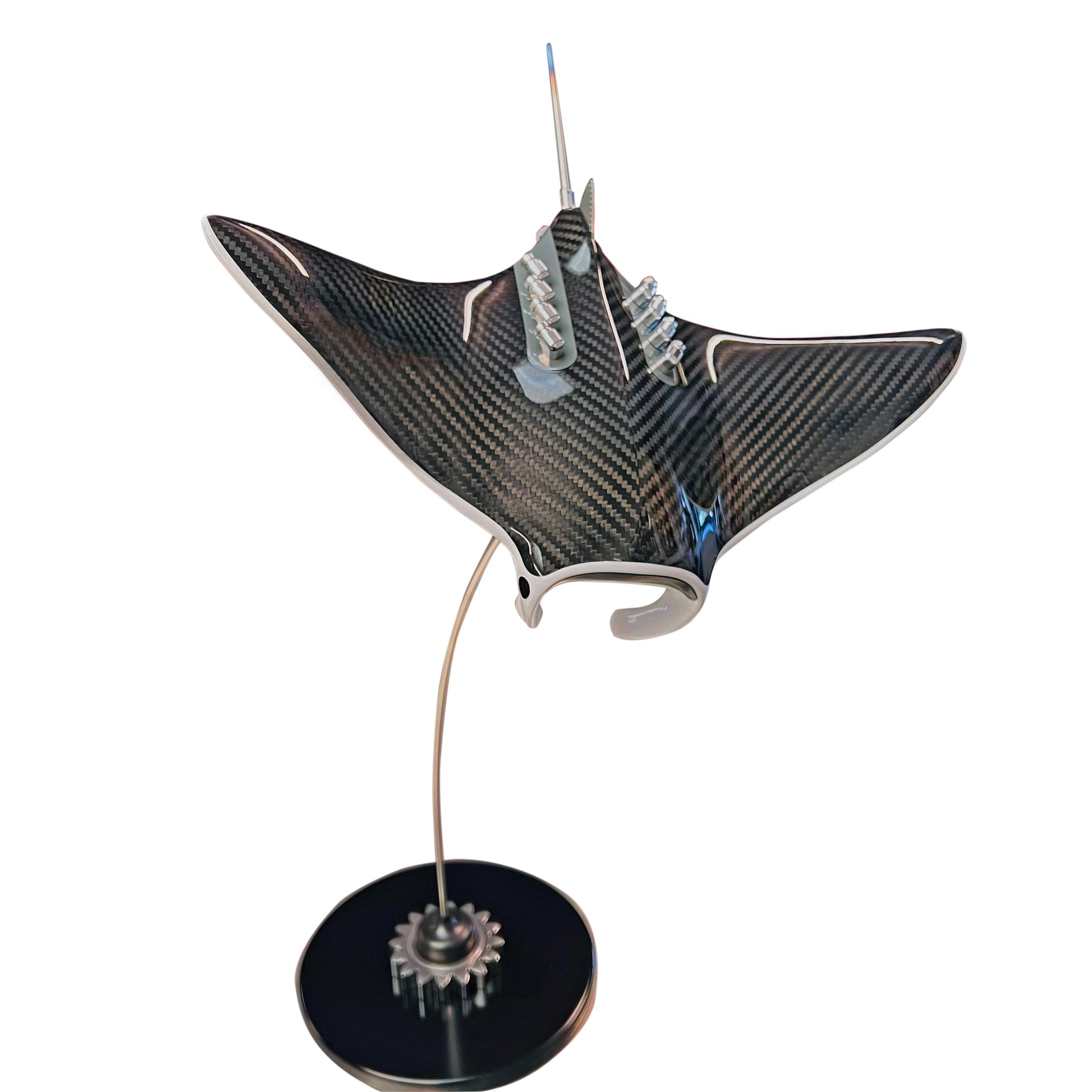 Carbon fibre Manta Ray sculpture on a black base with F1 gear