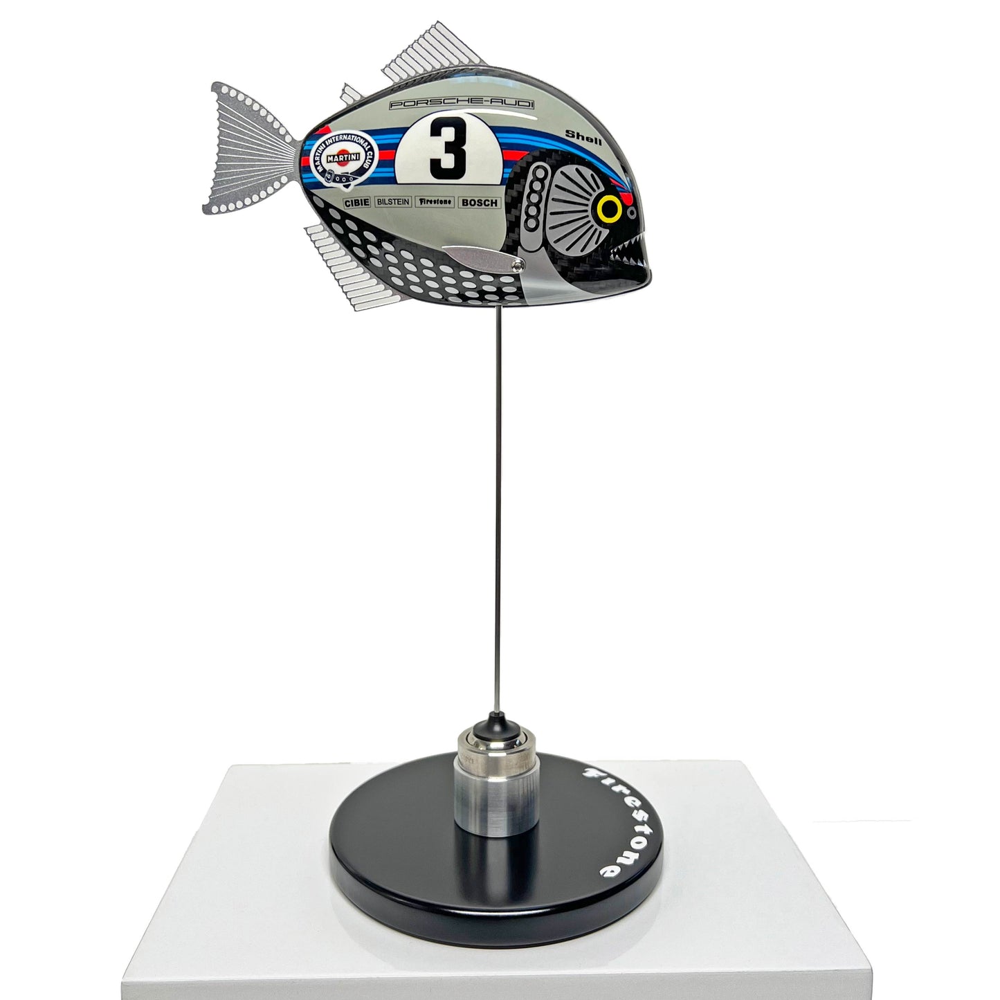 Carbon fibre Piranha sculpture with Martini Porsche livery on a black base with F1 parts