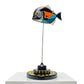 Carbon fibre baby piranha sculpture with McLaren F1 livery on a black base with F1 gear
