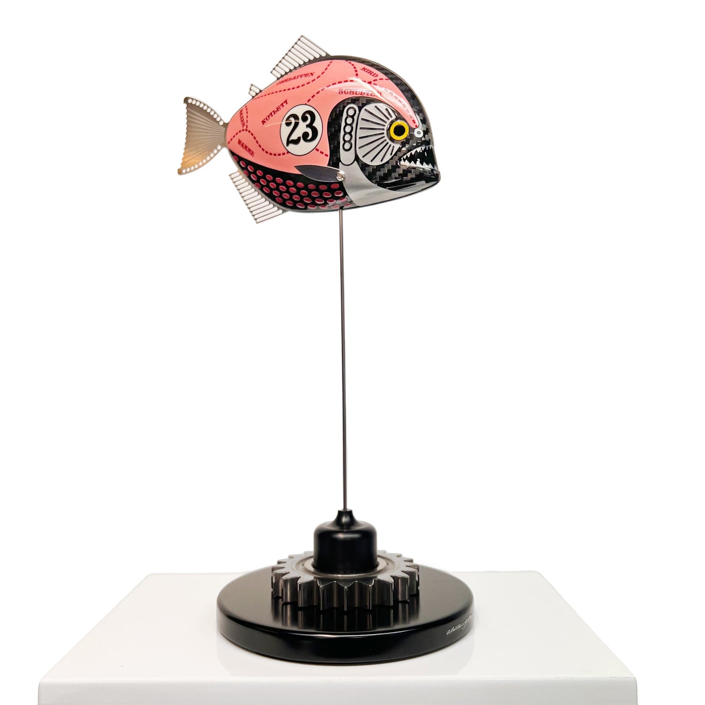 Carbon fibre piranha sculpture with Porsche Pink Pig livery on a black base with F1 gear