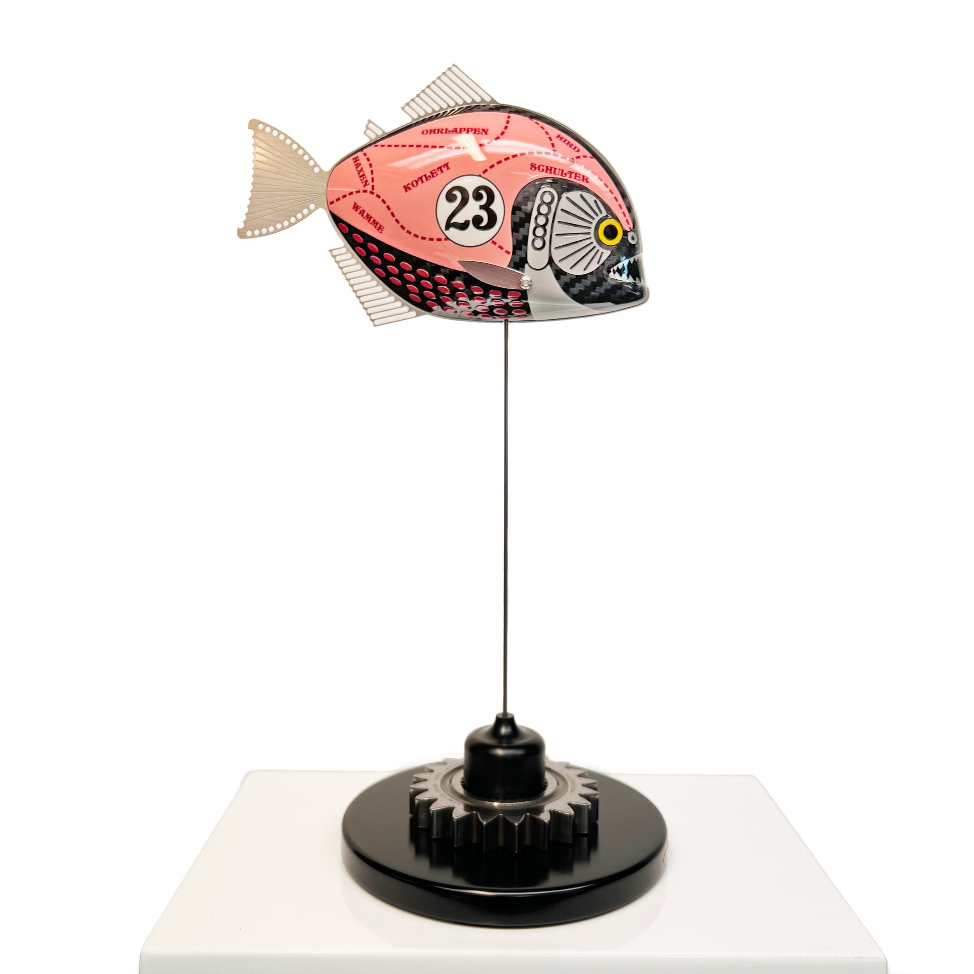 Carbon fibre piranha sculpture with Porsche Pink Pig livery on a black base with F1 gear